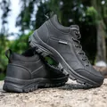 Black high-top leather hiking boots for men with durable non-slip soles on a rocky background - EU 39 / Black