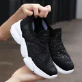 Women's black knit slip-on sneakers with silver shimmer and chunky white rubber soles - Black and White / EU 36