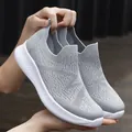 Women's grey knit slip-on sneakers with breathable mesh upper and white thick flexible sole - Gray