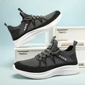 Moderne Laufschuhe aus grau-schwarzem Mesh mit AEFE-Logo auf weißer Aufbewahrungsbox - EU 40 / Grau