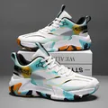 White basketball shoes for men with graffiti prints and orange accents on a display stand - EU 39 / White