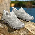 Grey breathable outdoor hiking shoe with non-slip rubber sole on a rugged rock surface - EU 36 / Gray