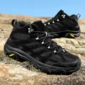 Black high-top outdoor hiking boots in suede and mesh on a rocky landscape - EU 36 / Black