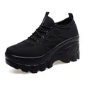 Women's black platform sneakers featuring a breathable knit upper and wedge heel design - EU 35 / Black