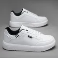 Detail view of white canvas sneaker showing the black fashion label and slip-resistant sole - 39 / White Black