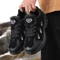 Men's black outdoor hiking shoes with durable rubber soles in a rugged rock environment - EU 39 / Black