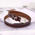 Detail of dark brown leather belt featuring white contrast stitching and silver pin buckle - Coffee