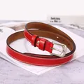 Detail of red leather narrow belt with matte silver buckle and white double stitching - 105cm / Red