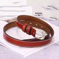 Detail of red-brown leather belt featuring white double stitching and matte silver buckle - 105cm / Red Brown