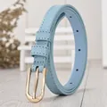 Light blue skinny leather belt for women with golden heart-engraved buckle on wooden desk - 105cm / Blue