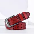 Elegant red leather belt with hollow flower carvings and dark gray metal buckle - Red