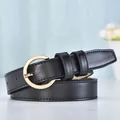 Classic black leather belt for women featuring a polished gold round buckle and stitching - Black Strap with Gold Buckle