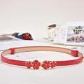 Vibrant red skinny belt for women with elegant golden butterfly flower buckle detail - Gold Four-Petal Buckle / Red