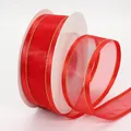 Red chiffon ribbon with gold edges on a white spool for DIY hair accessories and crafts - Red