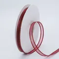 Deep red chiffon ribbon with gold stitched edges on a white plastic spool for DIY crafts - Burgundy
