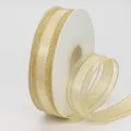 Champagne gold organza ribbon with glitter edges on white spool for DIY crafts - Light gold