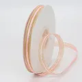 Pink ribbon with gold metallic edges on white spool for DIY gift wrapping - Pink
