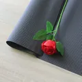 Corrugated black flower wrapping paper with vertical texture and red rose accent - Corrugated Paper / Black