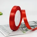 Single roll of bright red polyester satin ribbon for festive gift wrapping and DIY - Standard Bright Red Ribbon Style