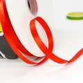 Vibrant red satin ribbon roll on white spool for gift wrapping and wedding decor - Narrow Standard High Density Red Ribbon