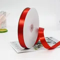 Single roll of glossy red polyester satin ribbon on a spool for gift wrapping - Medium Long Red Ribbon