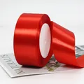 Single roll of vibrant red satin ribbon with glossy texture for gift wrapping - Extra Wide Standard Bright Red Ribbon