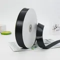Glossy black satin ribbon roll for gift wrapping and DIY crafts on a white background - Standard Long Paper Core Roll (BH-44)