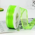 Neon green sheer organza ribbon with satin edges on a spool for gift wrapping - Fruit Green