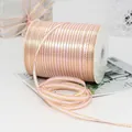 Pink satin ribbon with gold metallic edges on white spool for luxury gift wrapping - Pink with Gold Edge