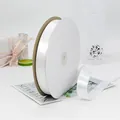 Glossy white satin ribbon roll for gift wrapping and floral bouquets on marble background - Satin Style / White