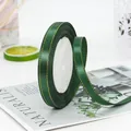 1cm dark green satin ribbon with gold edges on a spool for gift wrapping and DIY crafts - Dark Green
