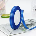 1cm navy blue satin ribbon with gold edge detail on a spool for gift wrapping - Sapphire Blue