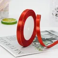 Single roll of red silk satin ribbon with gold trim edge for elegant gift wrapping - Red