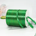 0.6cm dark green satin ribbon with gold edges on a spool for gift wrapping decoration - Green With Gold Edge