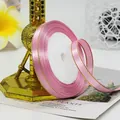 Pink satin ribbon with gold edges on roll for gift wrapping and DIY crafts - Medium Pink