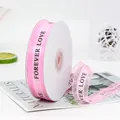 Pink sheer organza ribbon with black Forever Love print on a spool for cake gift wrapping - FOREVER LOVE / Pink