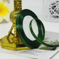 Deep green ribbon with gold edges wrapped on a spool for elegant gift packaging - Dark Green