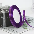 Deep purple satin ribbon with gold stitched edges for gift wrapping on a marble box - Purple