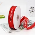 Red 2.2cm organza ribbon with white JUST FOR YOU print on a paper spool for gift wrapping - Just For You / Red