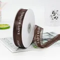 Deep brown 2.2cm organza ribbon with white Forever Love text on a white spool - FOREVER LOVE / Coffee