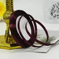 Deep burgundy 6mm satin ribbon roll with a glossy finish for gift wrapping and DIY crafts - Burgundy