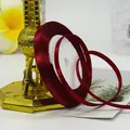 Deep red 6mm satin ribbon on white spool for elegant gift wrapping and DIY crafts - Burgundy