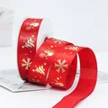 Red Christmas polyester ribbon with gold stamped snowflakes on a decorative roll - Red Snowman