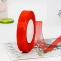 Roll of red sheer organza ribbon on white card spool for gift wrapping and DIY crafts - Red