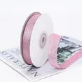 Pink glitter decorative ribbon on a white paper roll for DIY gift wrapping - Pink
