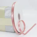 Pink high-density polyester satin ribbon on white spool for elegant gift packaging - Dusty Pink