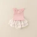 Pink sleeveless baby girl romper featuring delicate floral ruffles and a ribbed texture - 73cm / Pink