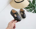 Detail shot of black girls' hollow-out T-strap Mary Janes with retro metal buckle design - 16 / Black