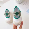 White canvas baby shoe with a green plaid bow and protective rubber toe cap - Size 24 / White