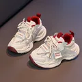 Lightweight breathable kids sneakers in white and red with cushioned rubber soles - EU 27 / Angola Red